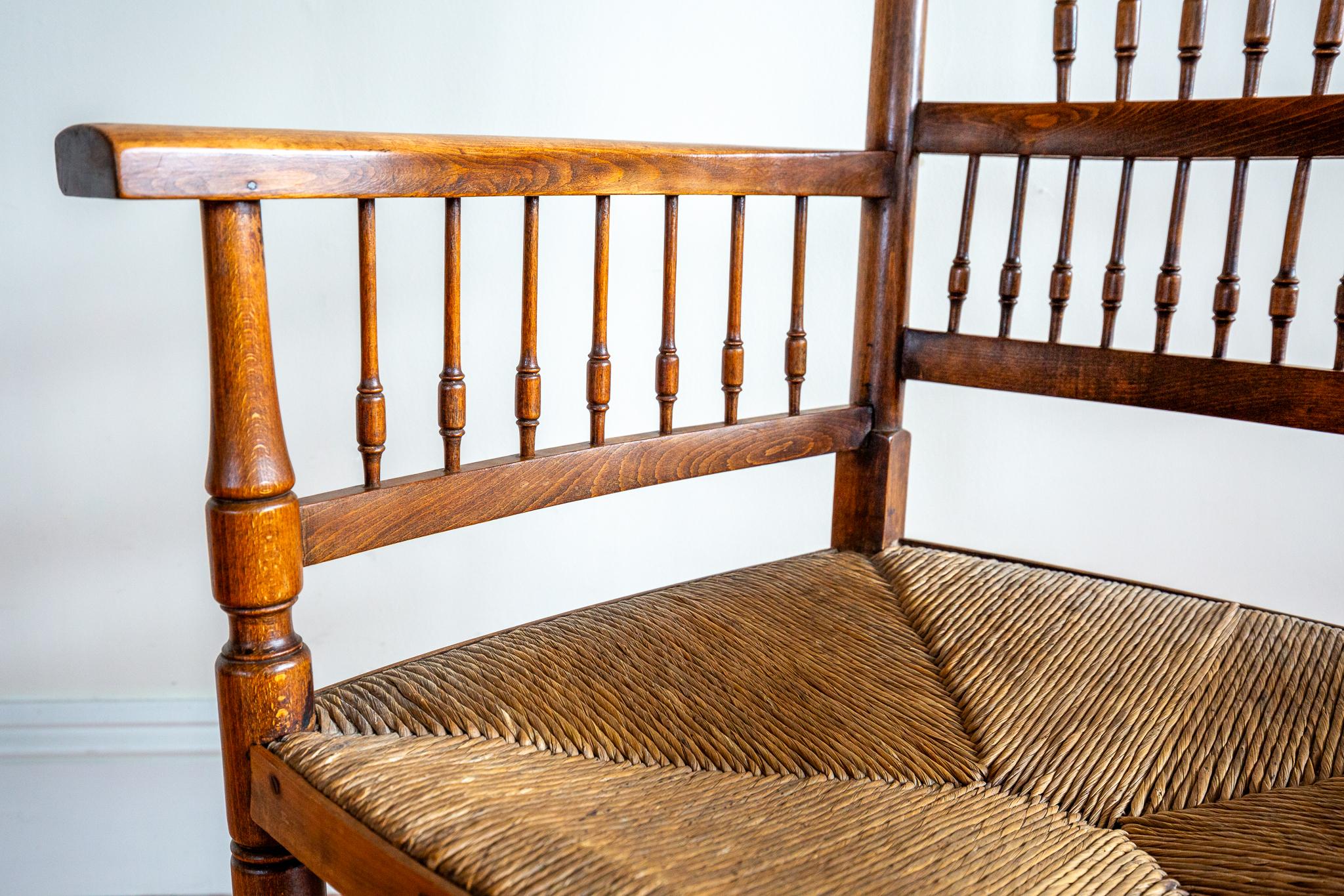 An outstanding and extremely rare William Morris style Arts & Crafts Sussex chair in wonderful antique condition. Attributed to E. G. Punnett and William Birch and almost certainly sold by Liberty of London around 1900-1910, this stunning armchair