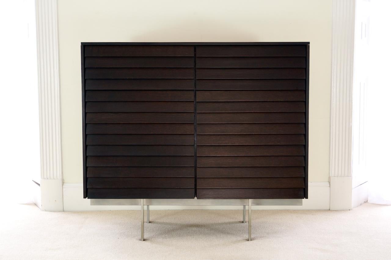 A gorgeous contemporary piece by British designer Terence Woodgate for high end Spanish furniture maker Punt Mobles, design year 2000.

The cabinet consists of two soft-closing drawers above two doors. Behind each door there is a height adjustable