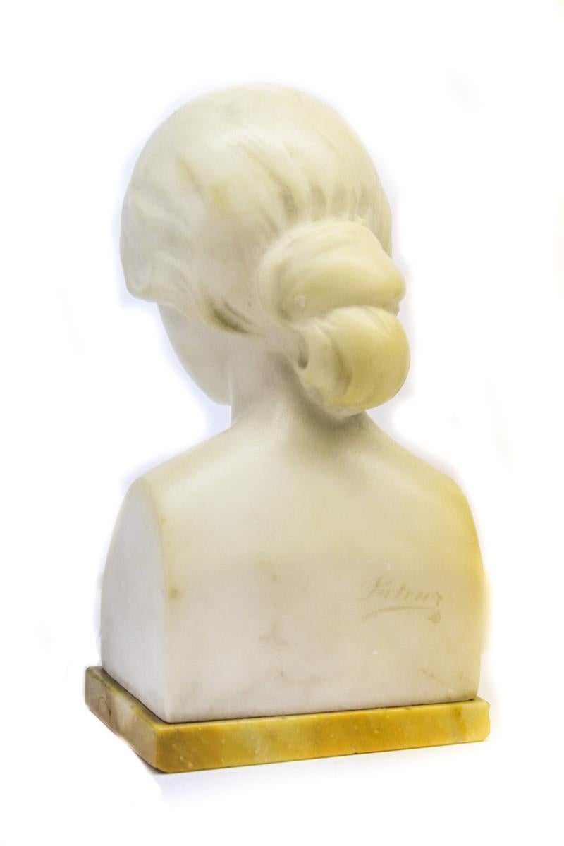 Carrara marble bust by Suteur for Schumacher & Co., depicting a young woman. The piece was made during the late 19th century and is marked 'Suteur' on the reverse and has a bronze 'Schumacher' bolt on the bottom of the gilt marble base.
