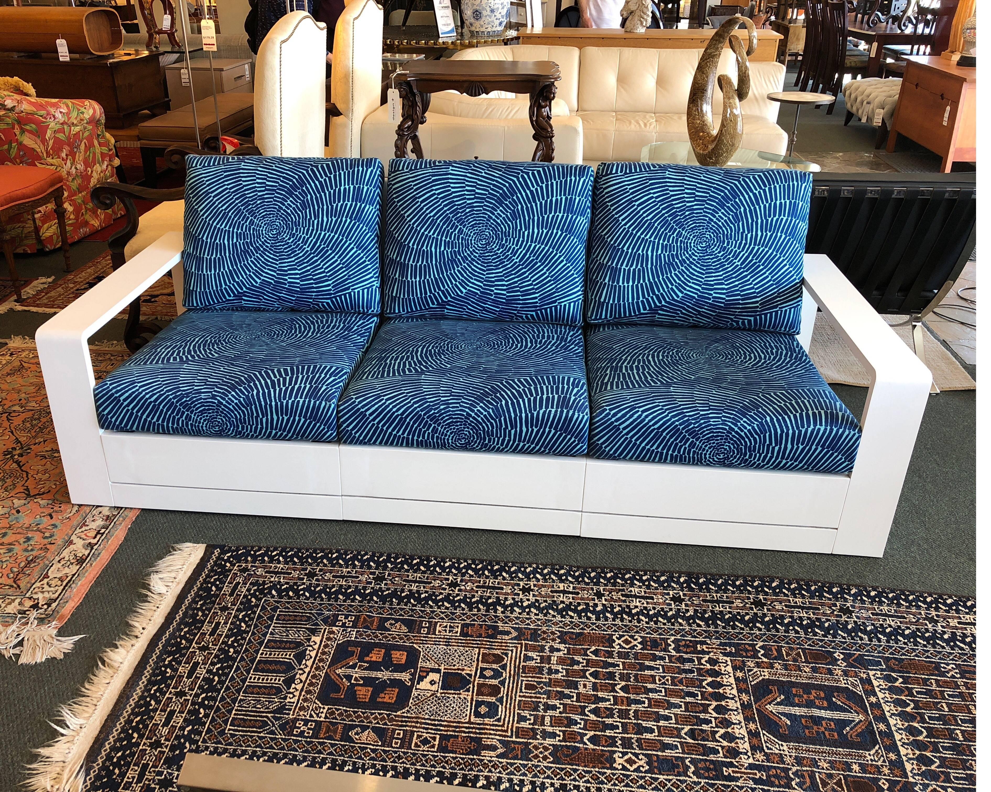 A Beacheside sofa. Designed by John Hutton. This three-seat has a aluminum frame with a snow powder coat finish. Upholstered in a blue Trina Turk fabric. The Beachside collection creates a carefree and laid-back lifestyle of living by the sea.
