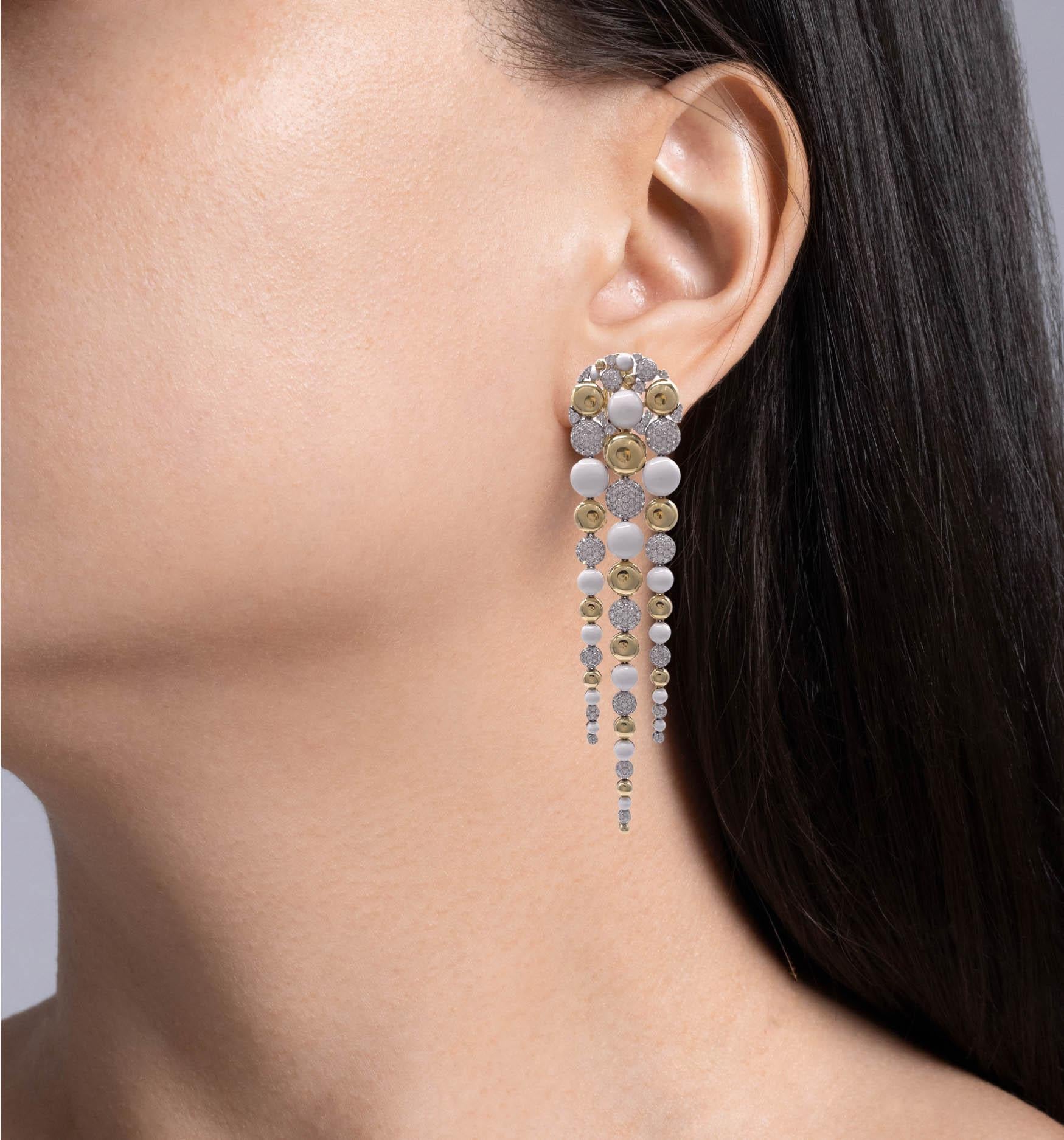 Sutra 18k Two Tone Gold Diamond White Ceramic Bubble Drop Dangle Earrings
Made of 18k Yellow and White Gold with small round brilliant diamonds.
Each earring is almost 4 inches long and 1 inch wide.
The total weight of the earrings is 33