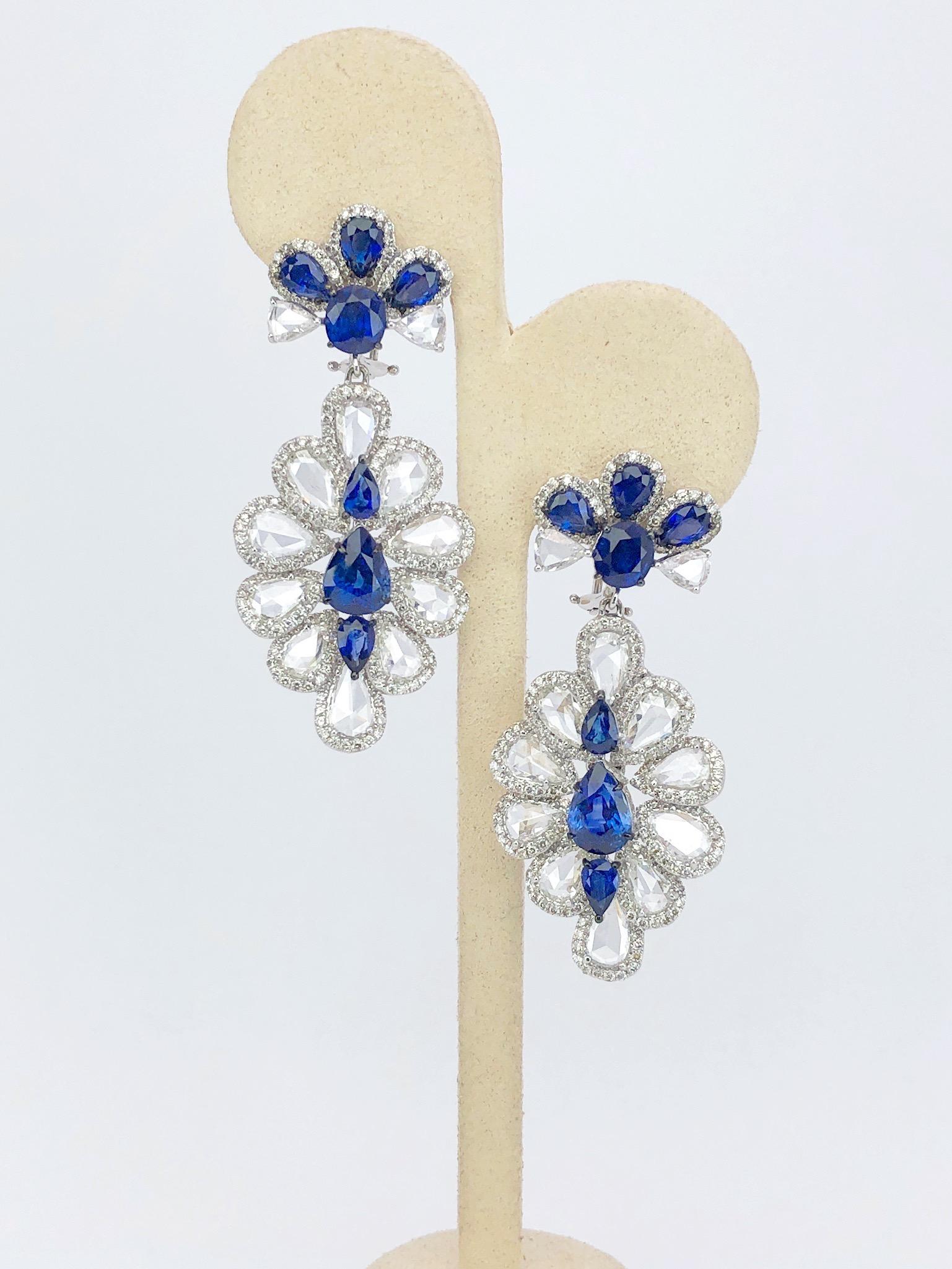 These magnificent 18 karat white gold sapphire and diamond earrings are composed of 12.51 carats of sapphires and 13.86 carats of rose-cut diamonds. The drops feature pear shaped blue sapphires surrounded by pear shaped rose cuts accented with pave