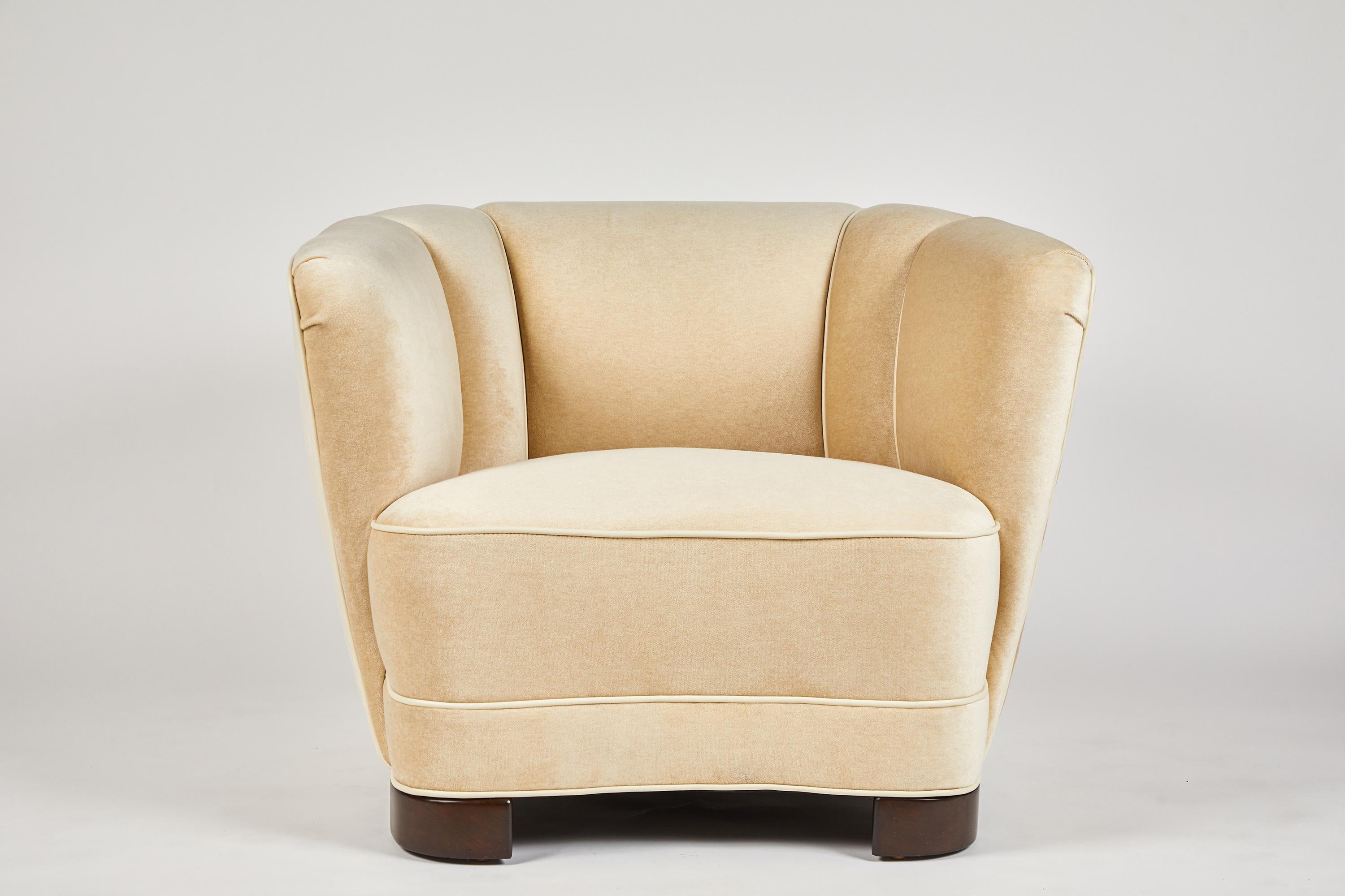 The Sutton Place club chair, as shown with feet. Also available in a swiveling version on a finished base. As with all of our custom furniture, fully customizable.