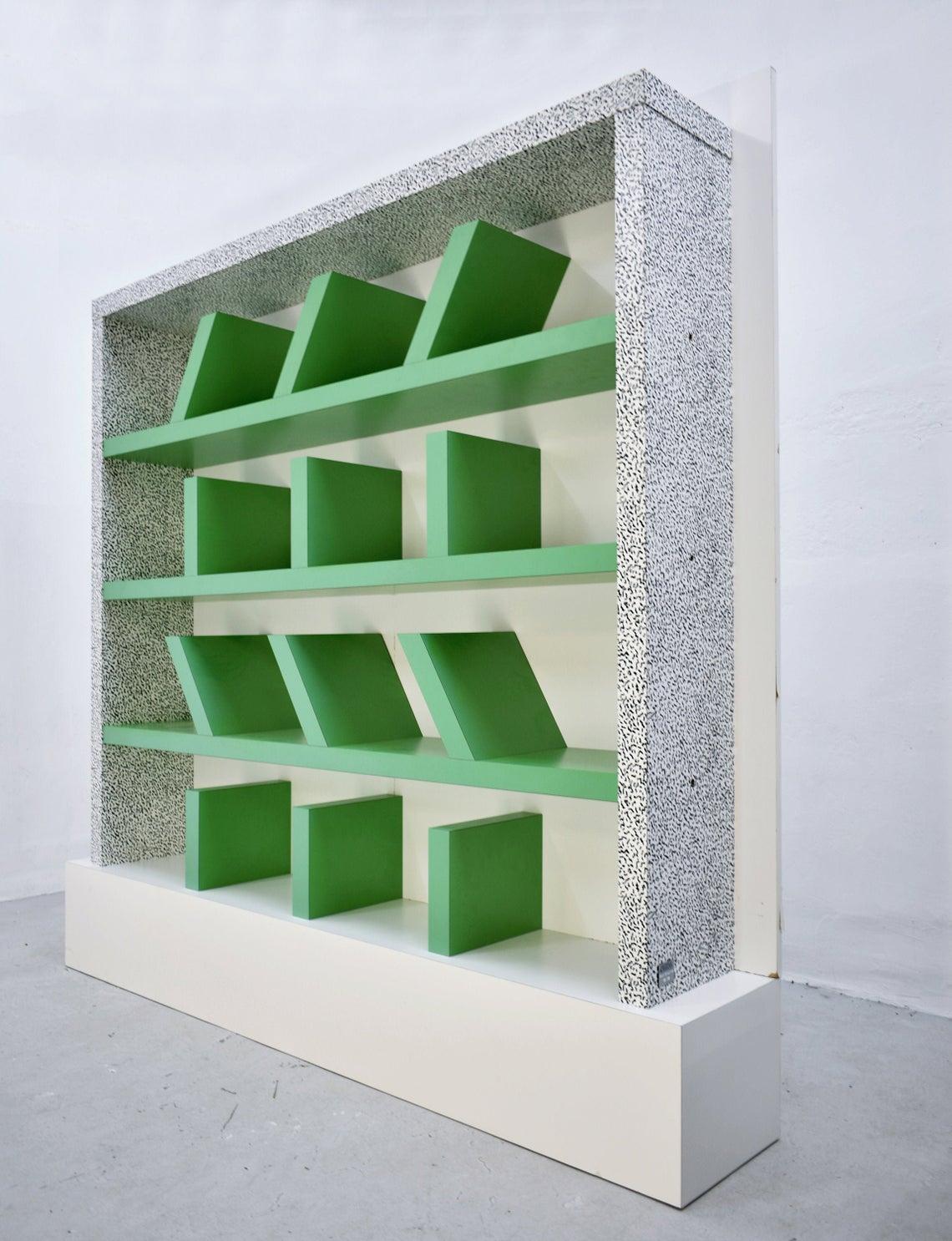 Original 'Suvretta' bookcase made of the wooden corpus in plastic laminate designed by Ettore Sottsass for Memphis Milano collection. The one offered here for sale was purchased in the early 1990s. It has a metal tag: Ettore Sottsass Memphis Milano