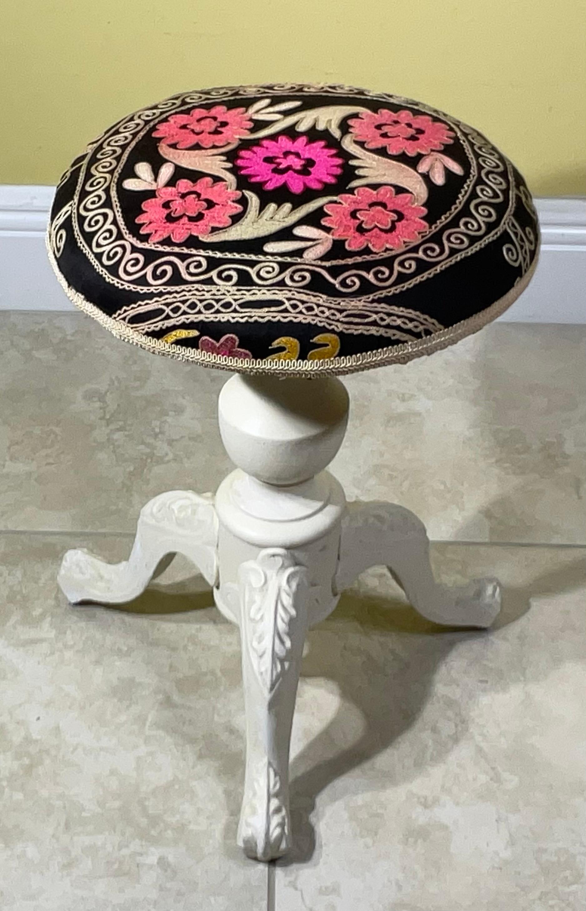 

Add a touch of global elegance and vibrant artistry to your home with this stunning, unique stool featuring authentic Suzani embroidery on a solid cast-iron base. This is more than just a seat; it's a conversation starter and a true collector's