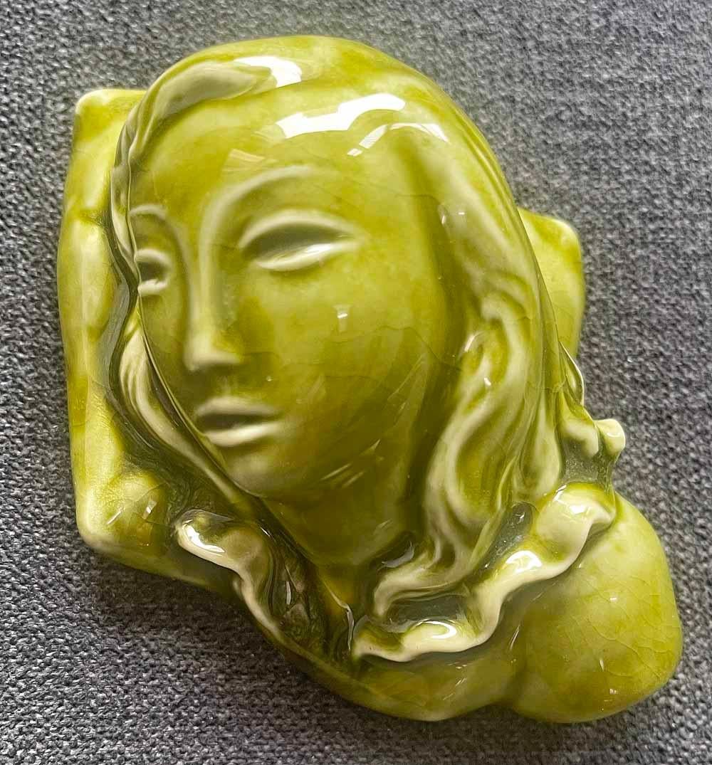 Rare, perhaps unique, this quintessential Art Deco sculptural object -- probably meant to serve as a paperweight -- was sculpted by David Warren Seyler for Kenton Hills Pottery in northern Kentucky. The female figure's long hair flows along her