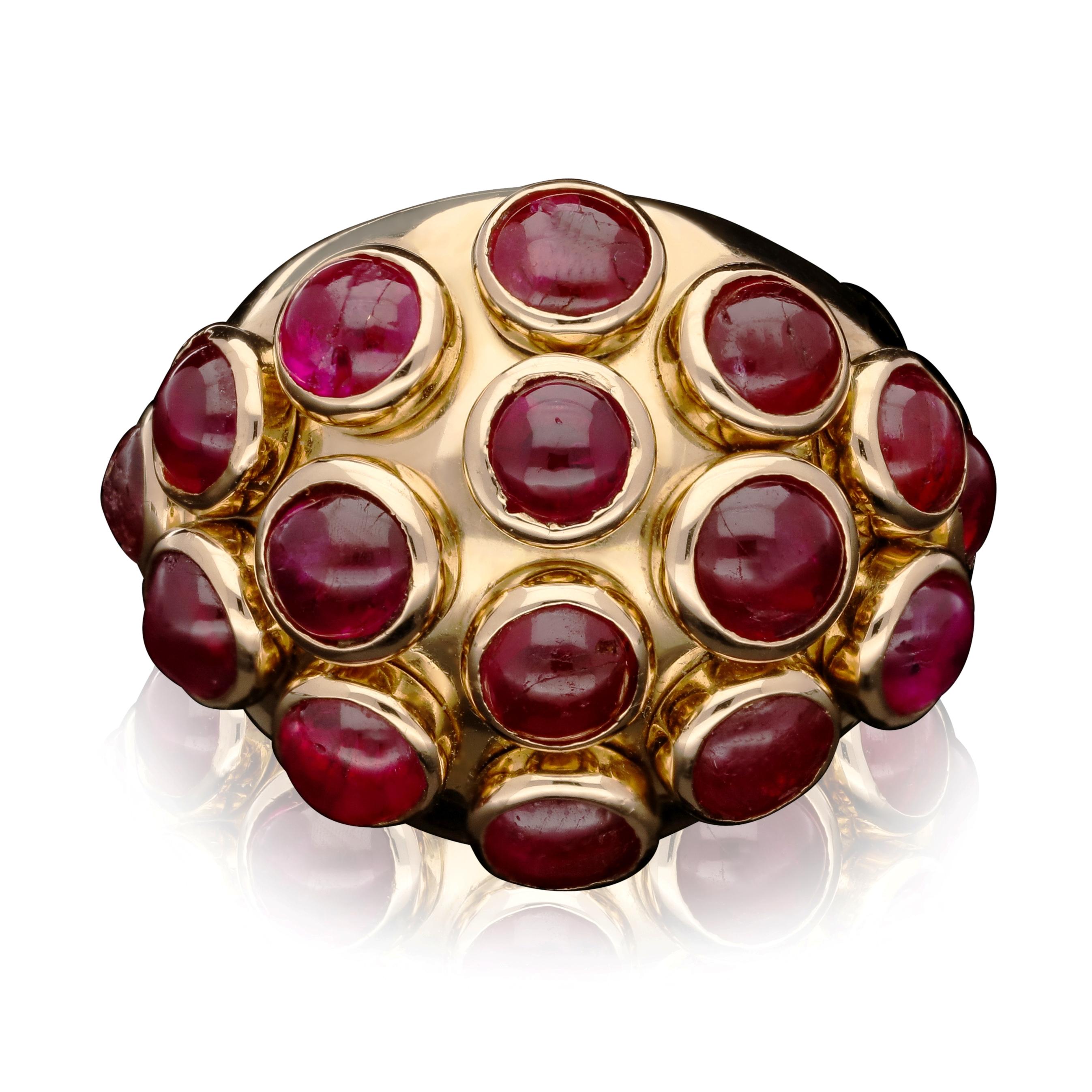 A fabulous Retro gold and ruby ring by Suzanne Belperron c.1940s, the bombe style ring in highly polished 18ct yellow gold with sixteen well matched ruby cabochons set in raised bezel settings across the front, in seven vertical rows tapering from