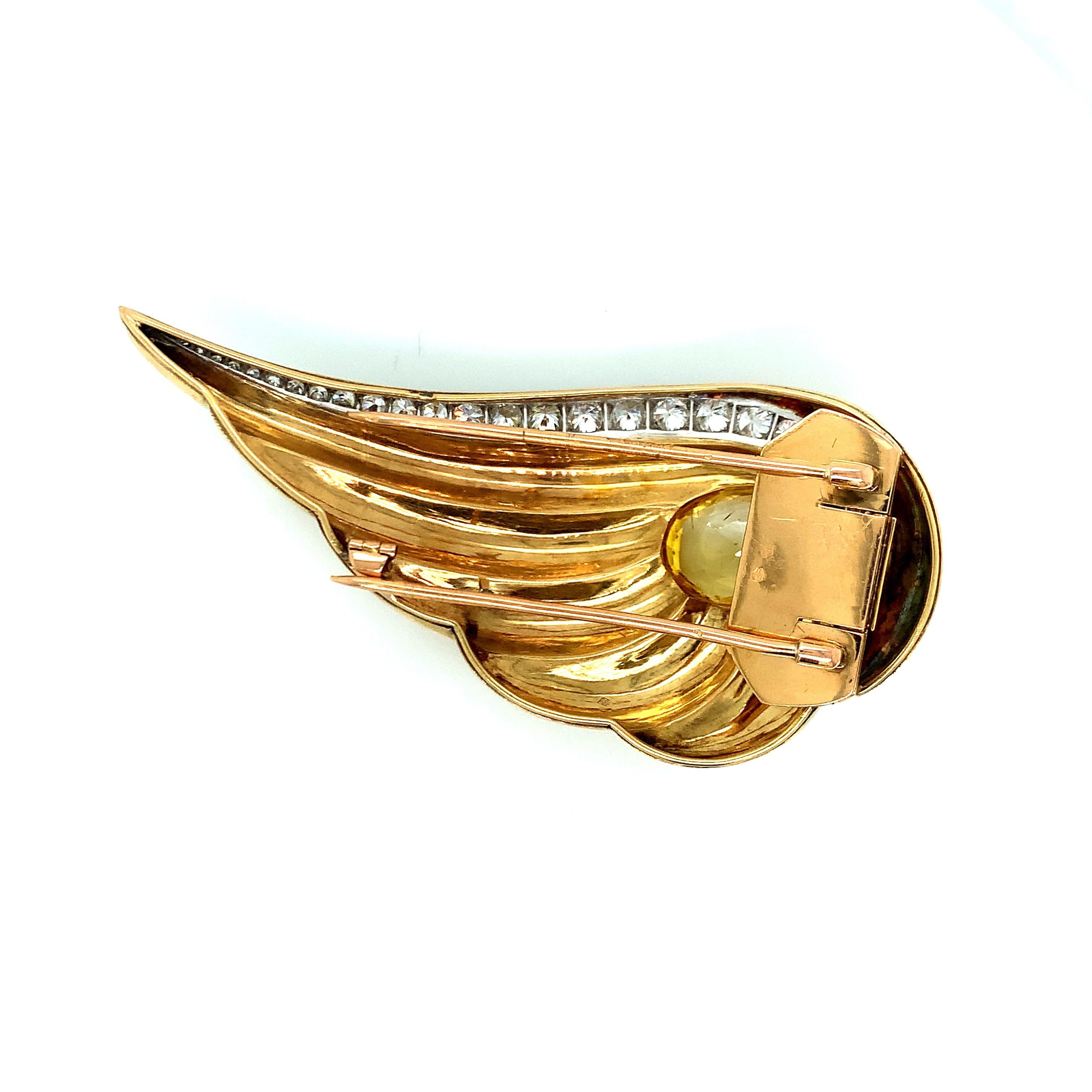 Crafted in 18 karat gold and platinum with a 14 karat pin clutch, this brooch is set with an oval-shaped yellow sapphire weighing a total of approximately 10.20 carats. Its diamonds are old-European, round, and single cut -- all weighing a total of