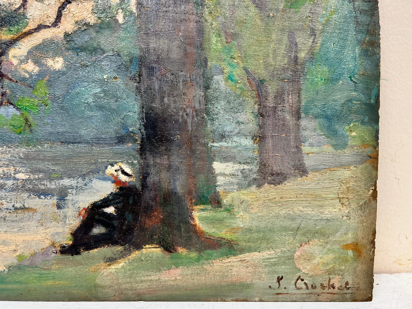 man sitting under tree painting
