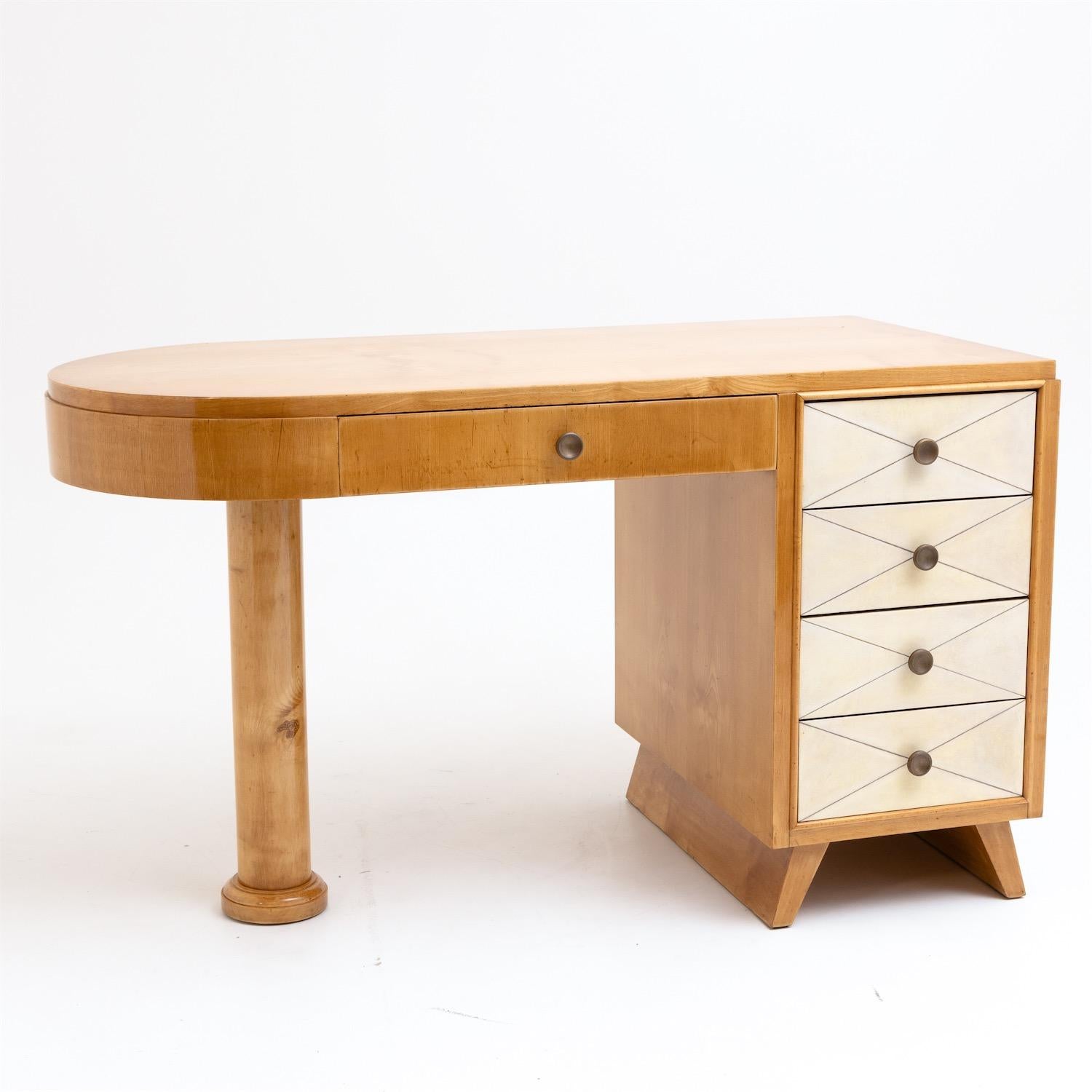 Small desk rounded at the left side and veneered in maple by Suzanne Guiguichon (1900-1985) with five drawers and columnar base. The right drawers are covered with a light-coloured parchment. The desk has been expertly restored and hand polished.