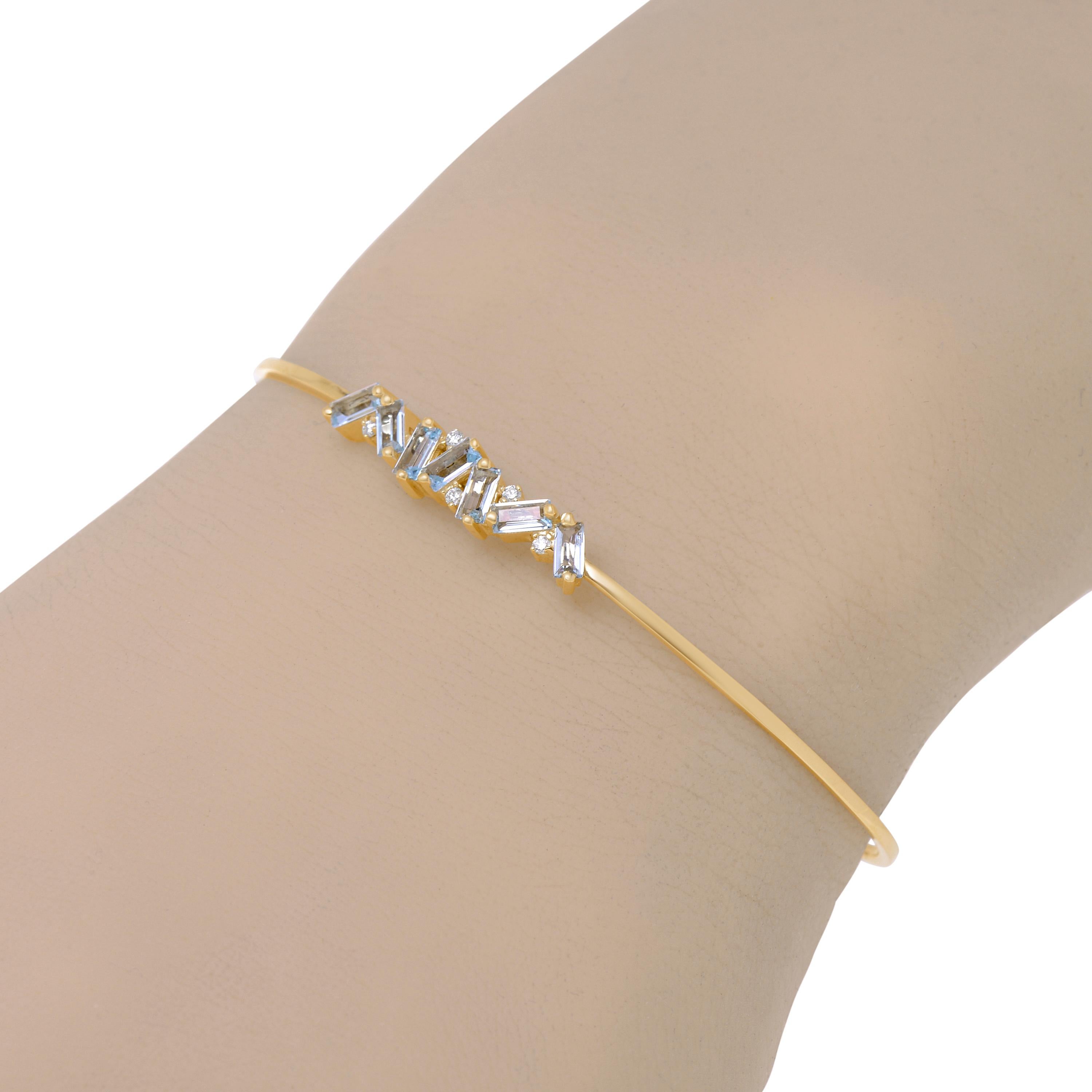 This charming Suzanne Kalan 14K Yellow Gold Bangle Bracelet features 0.05ct. tw. White Diamonds and Blue Topaz baguettes. Size medium . The Decoration Size is 25.9mm x 5.5mm. The Length is 6.25 inches. The Weight is 4.2g.
