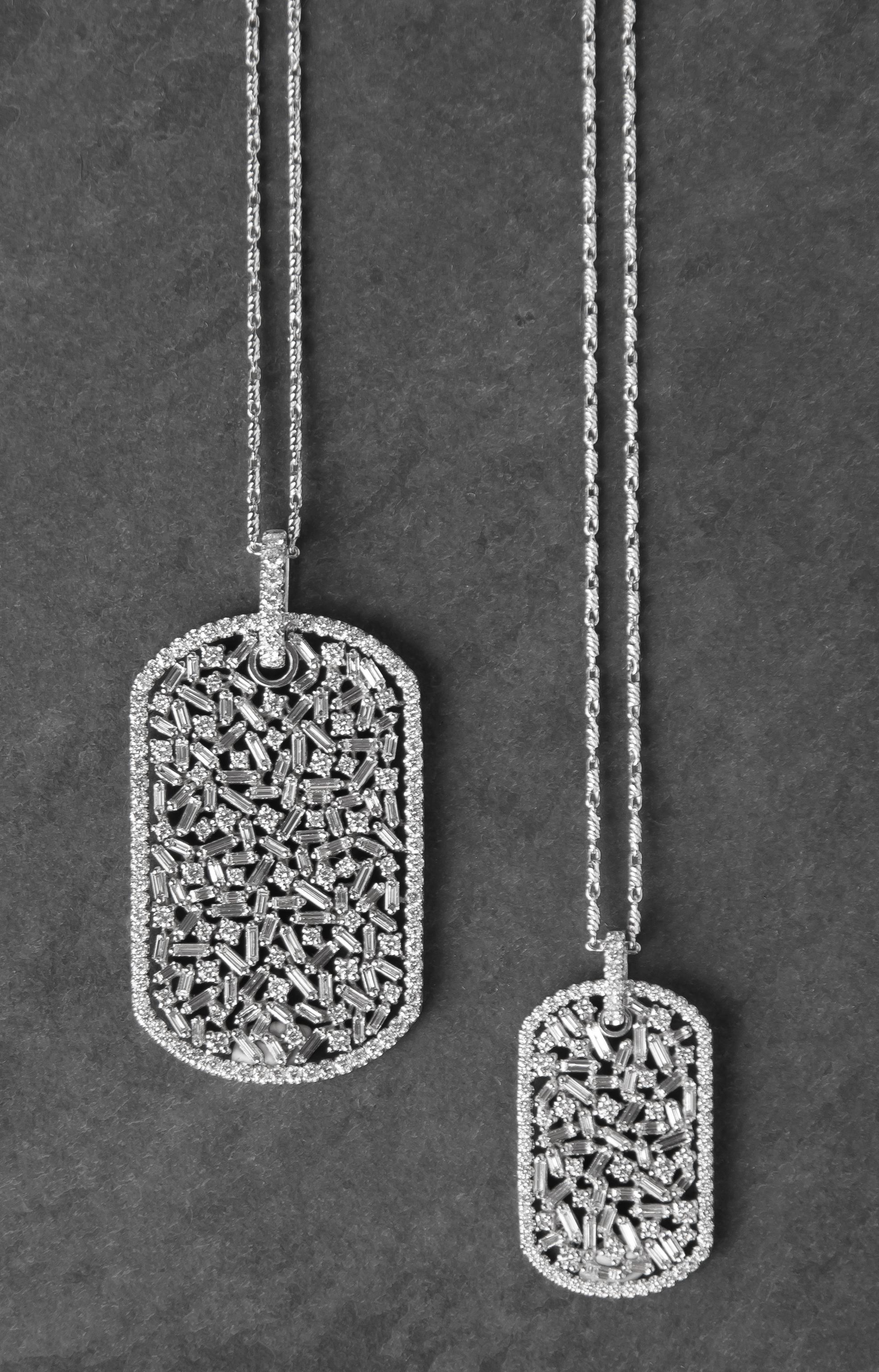 Designed as a military-style dog tag, but with a distinctly feminine flair, this medium pendant is crafted of white gold and set with round and baguette diamonds in a fireworks setting.

Pendant measures 1.1” long x 0.6” wide and is composed of