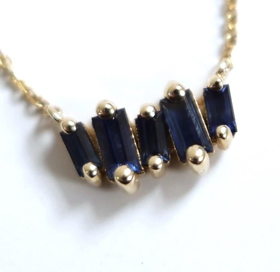Stunning Suzanne Kalan sapphire and gold necklace. Worn once. Made from 14kt yellow gold with bezel set 5 sapphire bar.  Measures approx 16” in total and bar is approx 0.5” wide. Comes with box/sleeve. 
