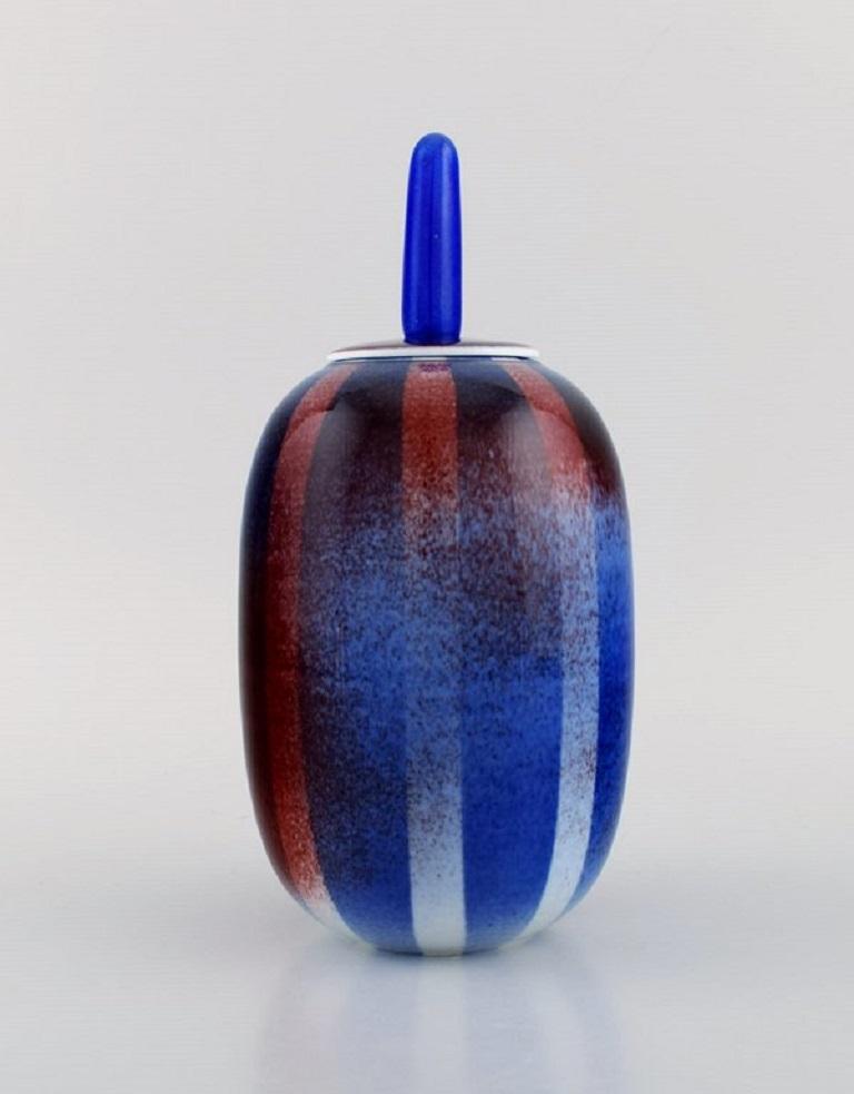 Suzanne Öhlén for Rörstrand. Lidded jar in glazed stoneware. Beautiful glaze in shades of blue and red. 
Striped design. 1980s.
Measures: 22.8 x 11 cm.
In excellent condition.
Signed.