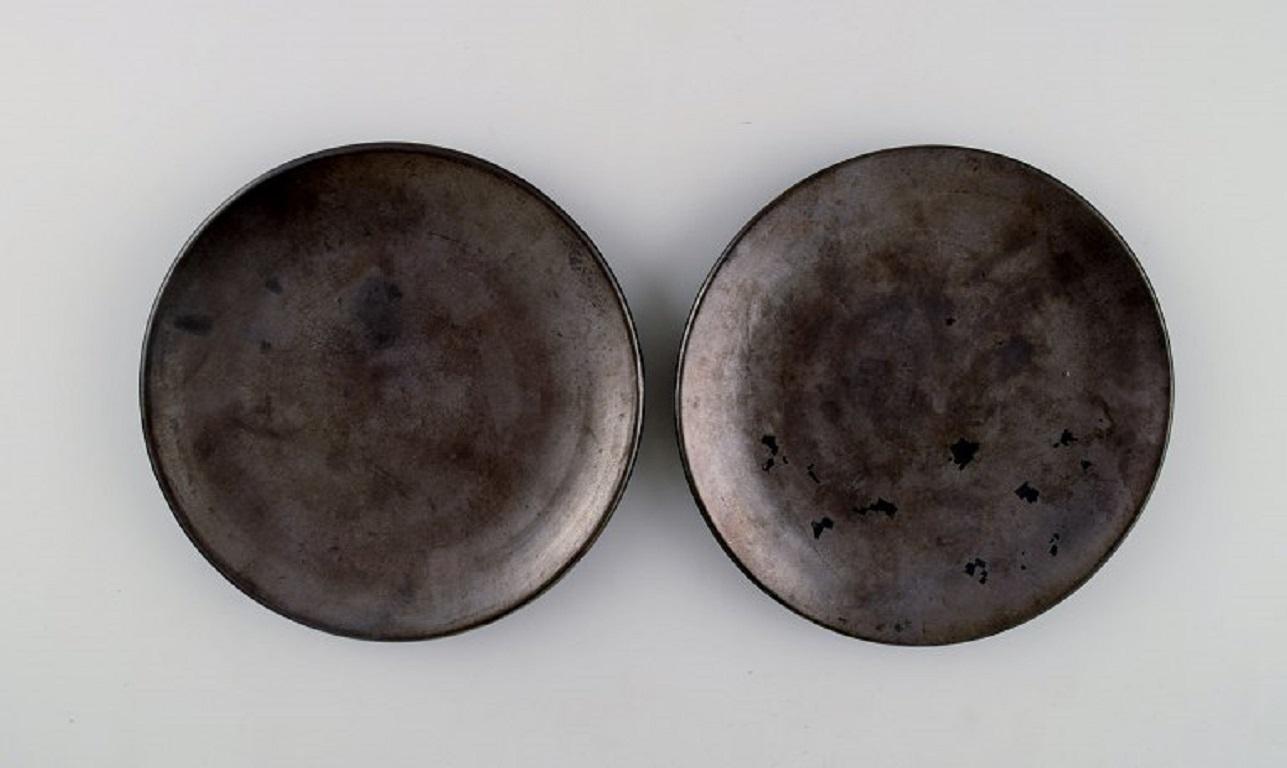 Suzanne Ramie (1905-1974) for Atelier Madoura. Five unique plates in glazed stoneware. 
Beautiful black metallic glaze. Mid-20th century.
Largest diameter: 16.5 cm.
In excellent condition.
Stamped.

Suzanne Ramié (1905-1974) is best known as