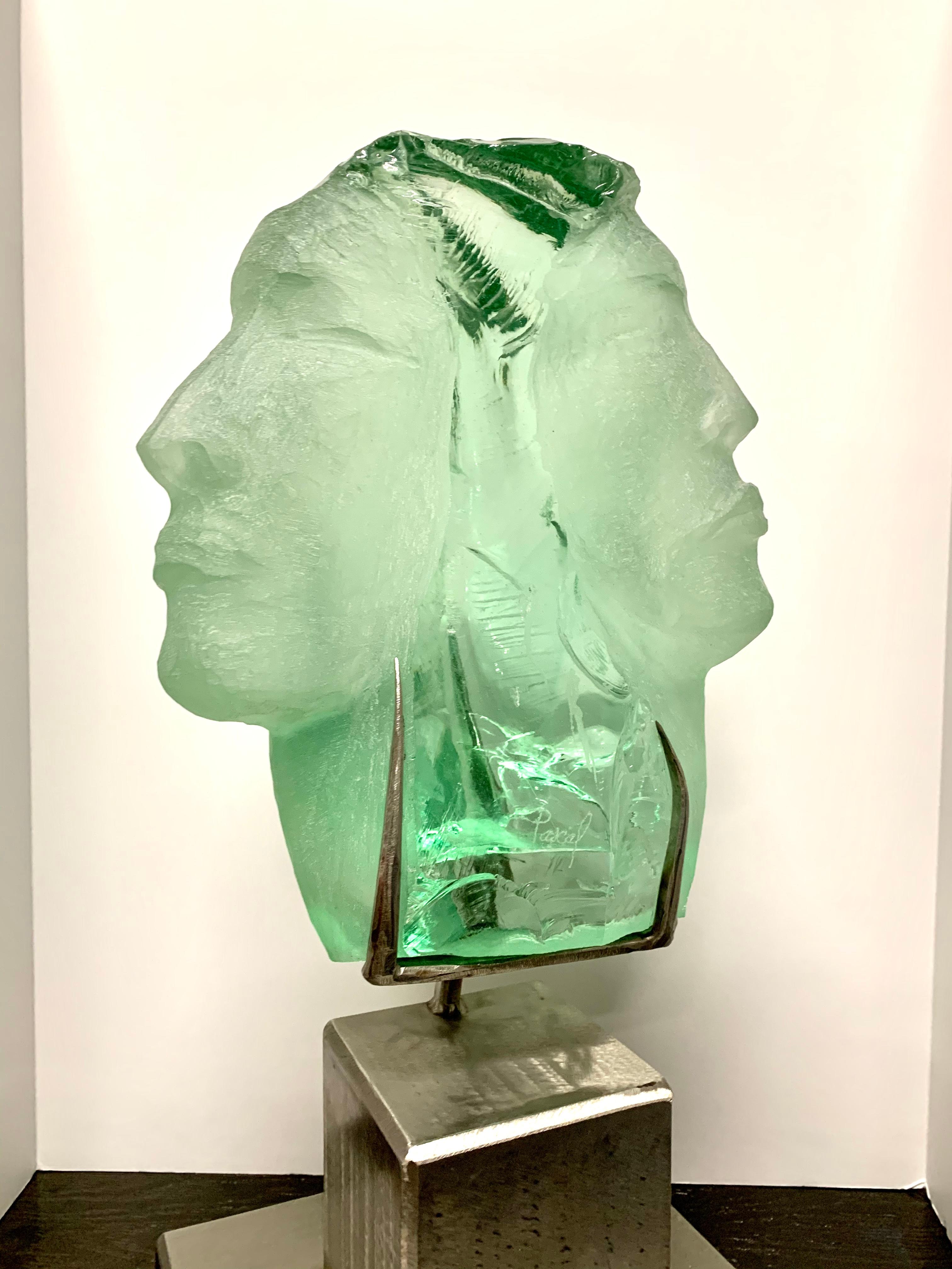 A beautiful glass sculpture by the noted artist Suzanne Regan Pascal. It is mounted on a steel base and measures slightly over 20 inches in height. The artist is in many important private collections, and her technique in carving slag glass was a