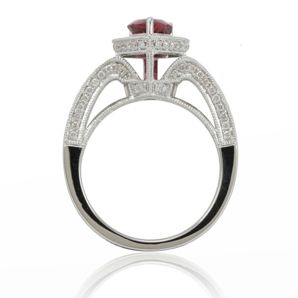Dazzle yourself or your loved one with this fabulous ruby and 14K white gold engagement or promise ring. Studded with 132 micro-pave diamonds (H-I, I1-I2) totaling .75cts, this limited edition ring features hand-carved French filigree work all
