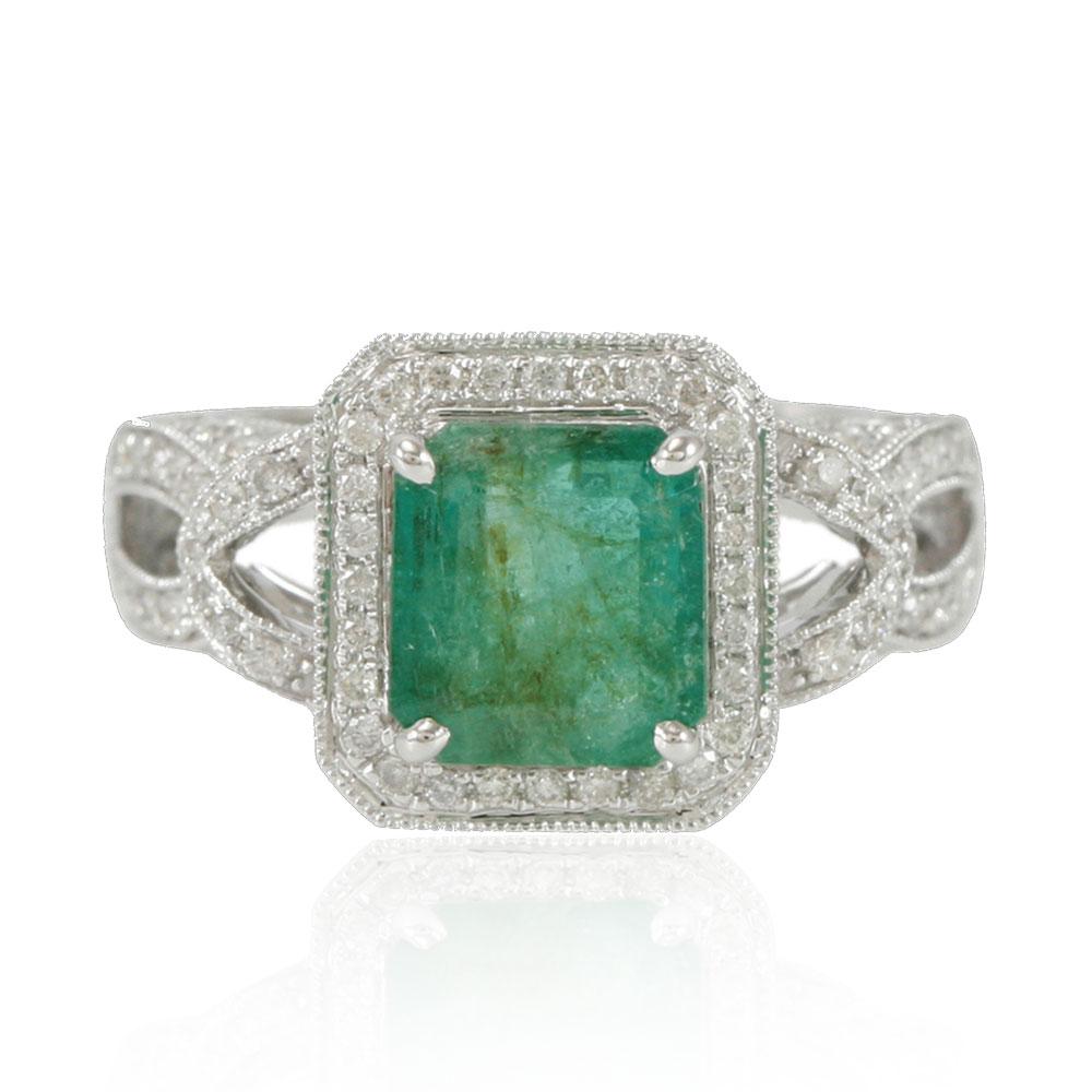 This spectacular ring from the Suzy Levian Limited Edition collection features a Colombian Emerald green gemstone held in a square shaped 14K white gold prong setting. An array of 118 side stone white diamonds (1.00ct) with hand-carved French
