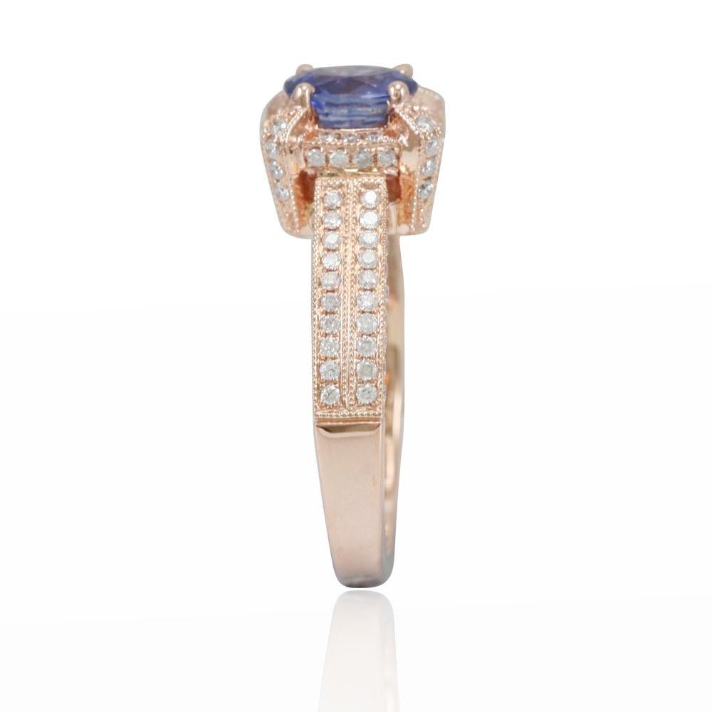 This spectacular solitaire-halo pave style ring from the Suzy Levian Limited Edition collection features an eye-clean ceylon blue sapphire held in a 14K rose gold prong setting. An array of 120 side white diamonds (.67ct) (G-H, SI1-2) with