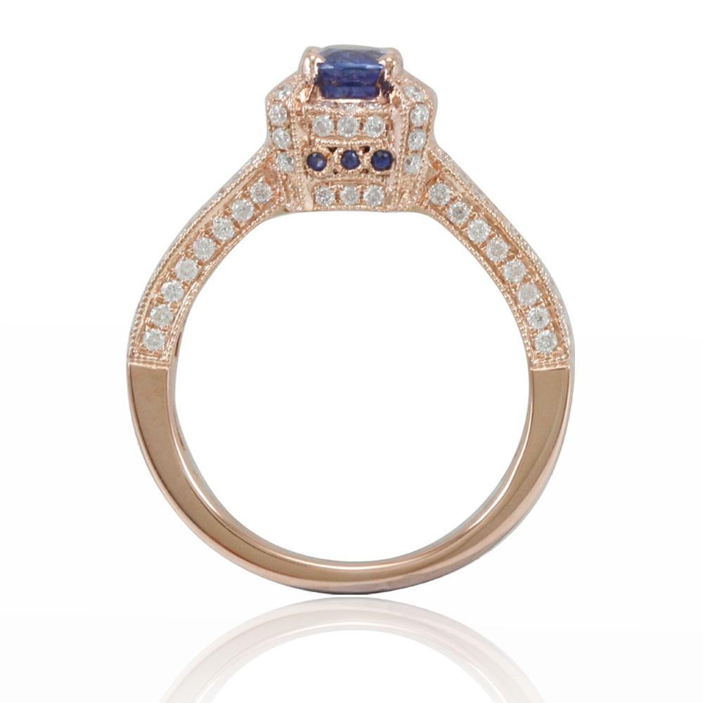 This spectacular solitaire-halo pave style ring from the Suzy Levian Limited Edition collection features an eye-clean Ceylon blue sapphire held in a 14K rose gold prong setting. An array of 120 side white diamonds (.67ct) (H-I, I1-I2) with