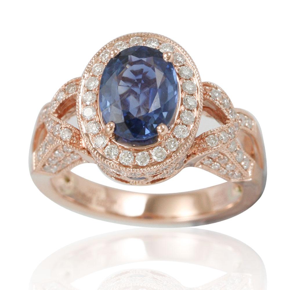This spectacular ring from the Suzy Levian Limited Edition collection features a ceylon sapphire gemstone held in a 14K rose gold prong setting. An array of 126 side white diamonds (.82ct) with hand-carved French filigree work across the band,