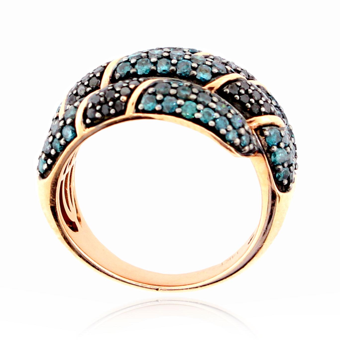 This spectacular ring from the Suzy Levian Limited Edition collection features pave blue and black diamonds (2.05 ct TDW) wrapped around your finger in a 14k rose gold setting. The crossover pattern is both delicate and bold as it blends together