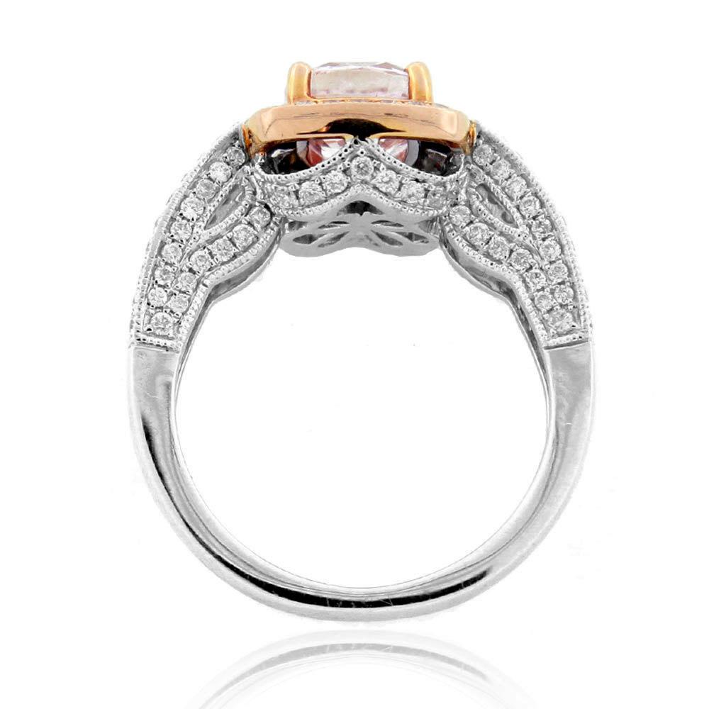 This spectacular ring from the Suzy Levian collection features 14k two-tone rose and white gold. An array of white diamonds (.84cttw) accent the perfect cushion-cut, pink morganite gemstone center (1.71ct). The brilliance of these stones and the