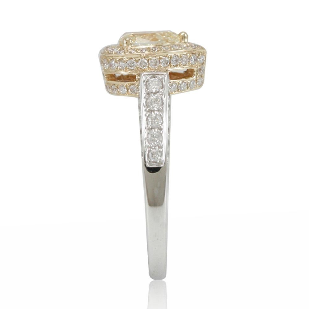 This spectacular ring from the Suzy Levian Limited Edition collection features a gorgeous pear-cut, fancy yellow diamond (.50ct) center stone with an array of white diamonds (.63cttw) accents, handset in a 14k two-tone white and yellow gold setting.