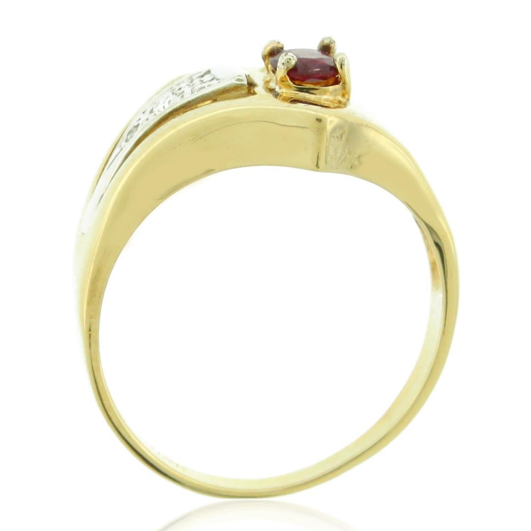 This bold ring features a vintage design with a modern edge as it centers an oval-cut ruby center stone (0.20ct) accented by 4 white round-cut diamonds (0.15ct). Creating a sharp look, this ring is crafted of two-tone 14K yellow gold with a white