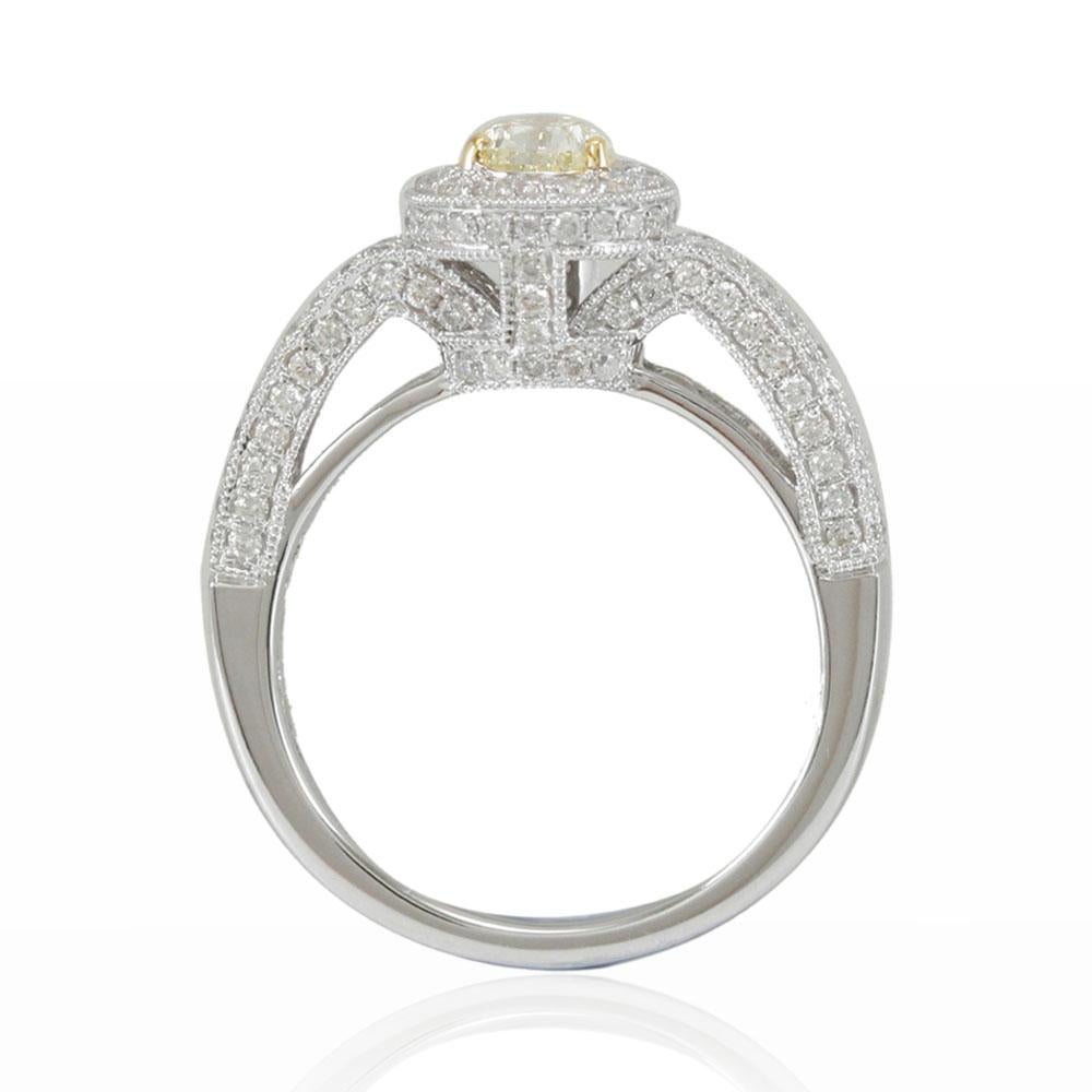 This stunning ring from the Suzy Levian Limited Edition collection features a gorgeous pear-cut, natural light fancy yellow diamond (.71ct) center stone with an array of white diamond (.90cttw) accents, handset in a 14k two-tone white and yellow