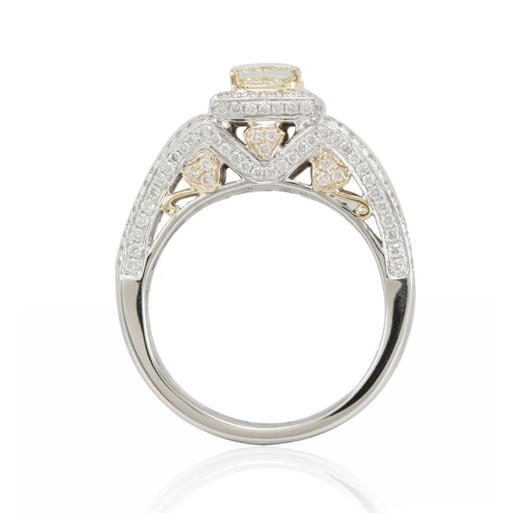 This spectacular ring from the Suzy Levian bridal collection features 14k two-tone white and yellow gold. An array of pave white diamonds (.80cttw) accent the band as a square-cut, natural fancy yellow diamond center stone (.69ct) is highlighted in