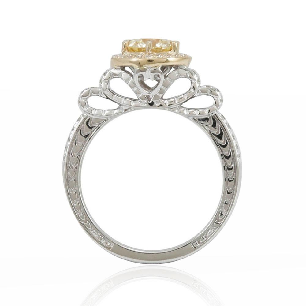 This spectacular ring from the Suzy Levian Limited Edition collection features a two-tone 14k white and yellow gold setting with a round-cut, fancy yellow diamond center stone (1.08ct) . An array of white diamonds (.31cttw) accents the ring