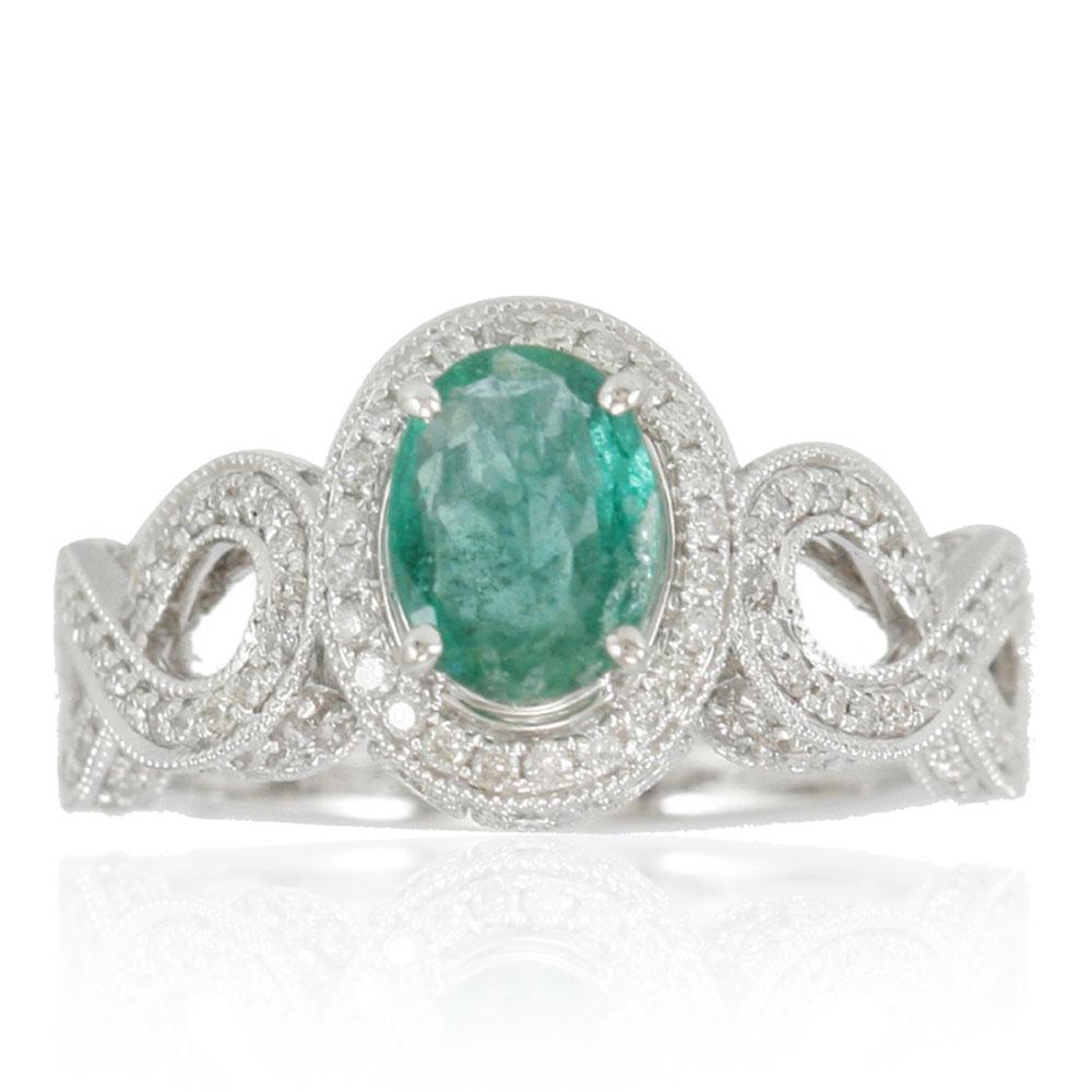 This spectacular ring from the Suzy Levian Limited Edition collection features a Colombian emerald gemstone held in a 14K white gold prong setting. An array of side white diamonds (.84cttw)(SI1-SI2, H-I) with hand-carved French filigree work across