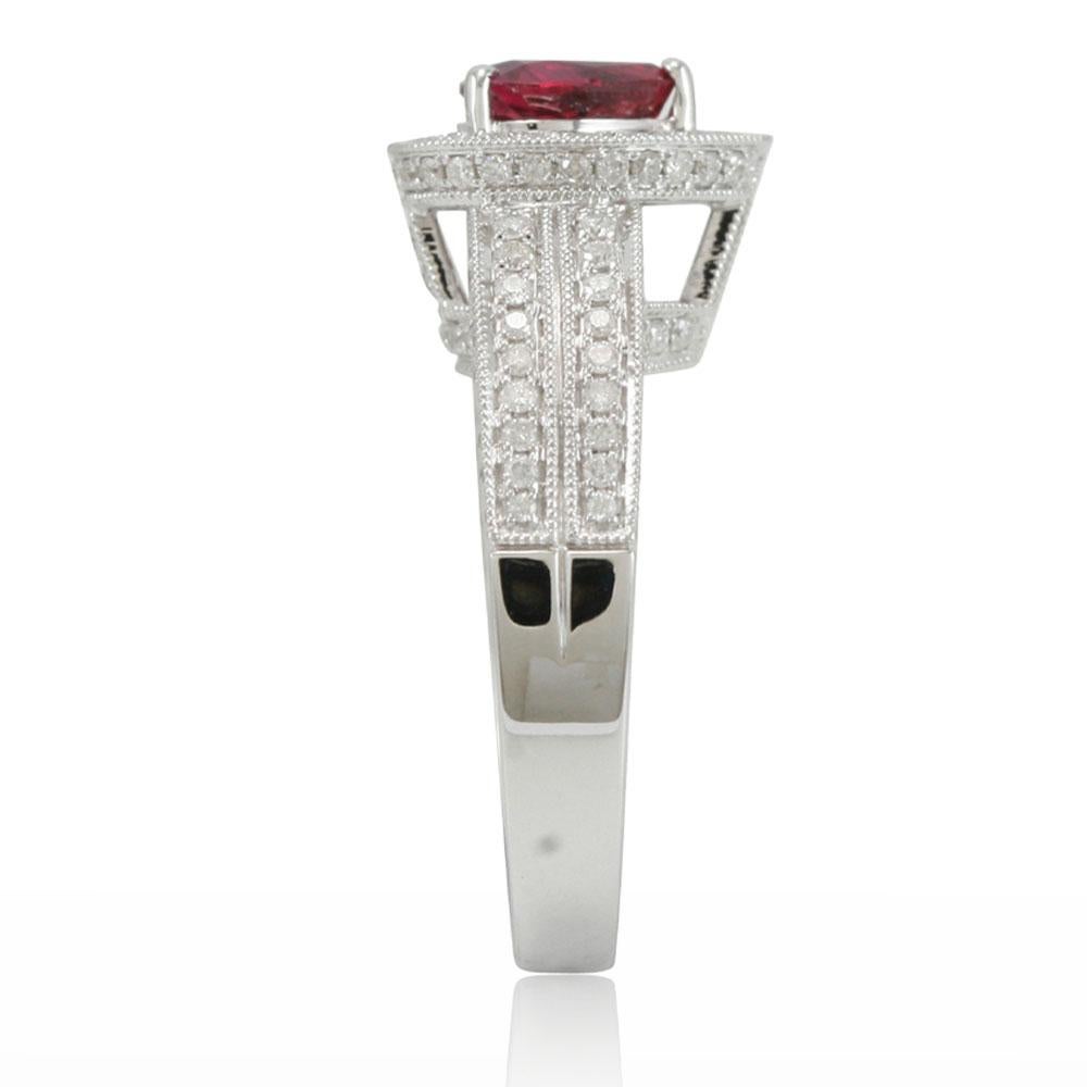 Dazzle yourself or your loved one with this fabulous ruby and 14K white gold engagement or promise ring. Studded with 132 micro-pave diamonds (H-I, SI1) totalling .75cts, this limited edition ring features hand-carved French filigree work all across