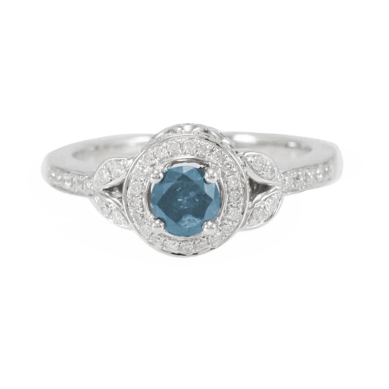 This stunning ring from the Suzy Levian Limited Edition collection features a gorgeous round-cut, fancy blue diamond (.36ct) center stone with an array of white diamond (.41cttw) accents, handset in a 14k white gold setting. French filigree