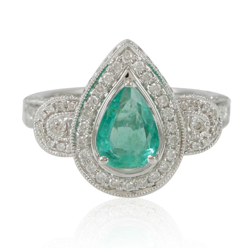 This spectacular ring from the Suzy Levian collection features a Colombian emerald gemstone (1.10ct) held in a pear shaped 14K white gold prong setting. An array of 179 side white diamonds (.96cttw) (H-I, SI1) with hand-carved French filigree work