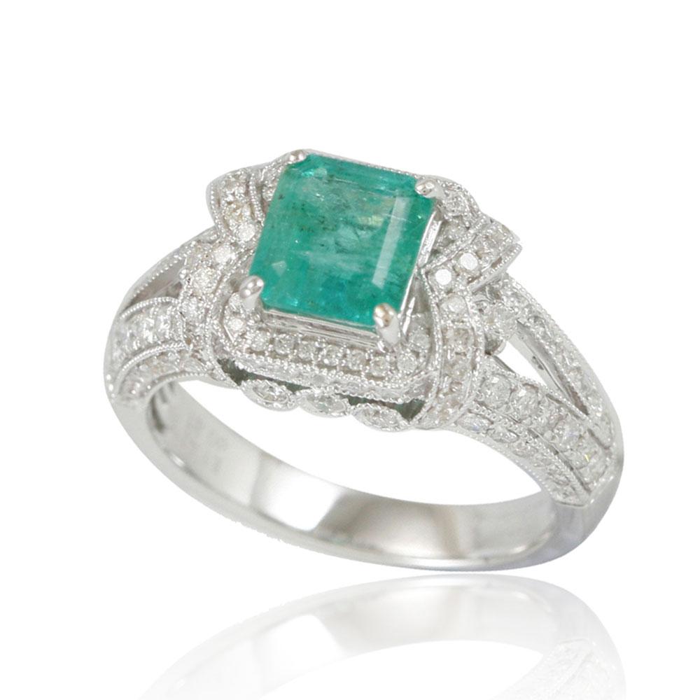 This spectacular ring from the Suzy Levian Limited Edition collection features a Colombian emerald gemstone held in a square shaped 14K white gold prong setting. An array of 120 side white diamonds (.87ct) with hand-carved French filigree work