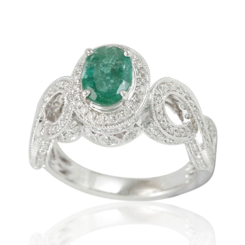 This spectacular ring from the Suzy Levian Limited Edition collection features a Colombian emerald gemstone held in a 14K white gold prong setting. An array of side white diamonds (.84ct) with hand-carved French filigree work across the band,
