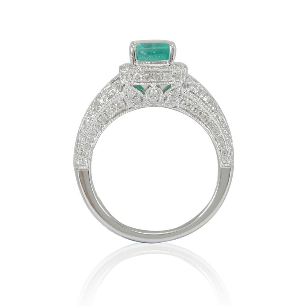 This spectacular ring from the Suzy Levian Limited Edition collection features a Colombian emerald gemstone held in a square shaped 14K white gold prong setting. An array of 105 side white diamonds (1.10ct) with hand-carved French filigree work
