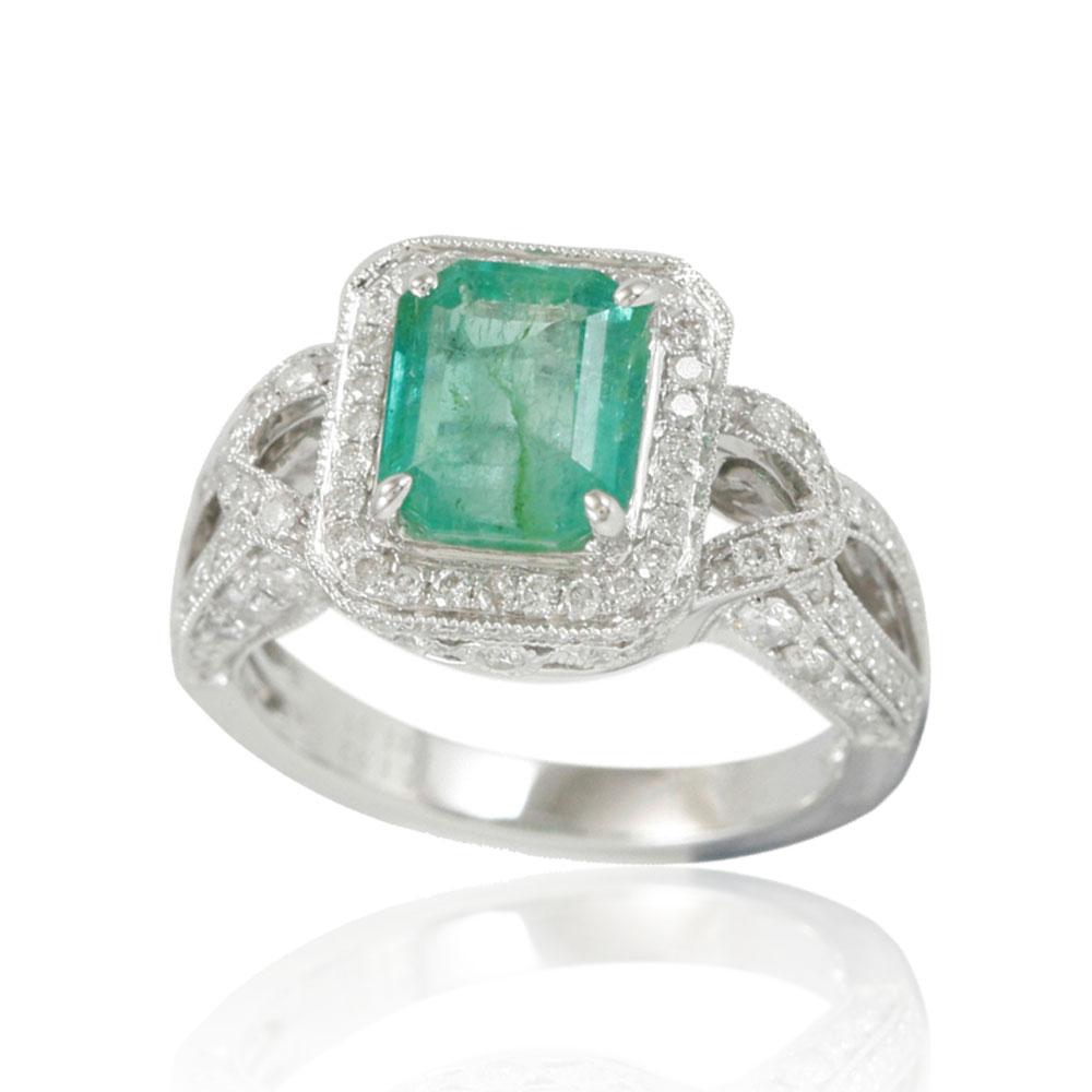 This spectacular ring from the Suzy Levian Limited Edition collection features a Colombian emerald gemstone held in a square shaped 14K white gold prong setting. An array of 118 side white diamonds (1.04cttw) with hand-carved French filigree work