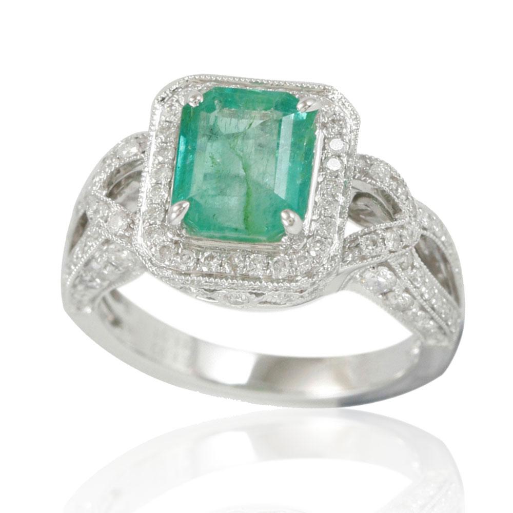 This spectacular ring from the Suzy Levian Limited Edition collection features a Colombian emerald gemstone held in an emerald-shaped 14K white gold prong setting. An array of 138 side white diamonds (1.01ct) with hand-carved French filigree work