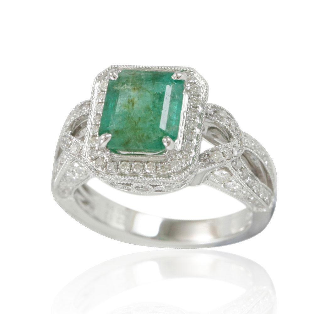 This spectacular ring from the Suzy Levian Limited Edition collection features a Colombian emerald gemstone held in a square shaped 14K white gold prong setting. An array of 118 side white diamonds (0.99ct) with hand-carved French filigree work