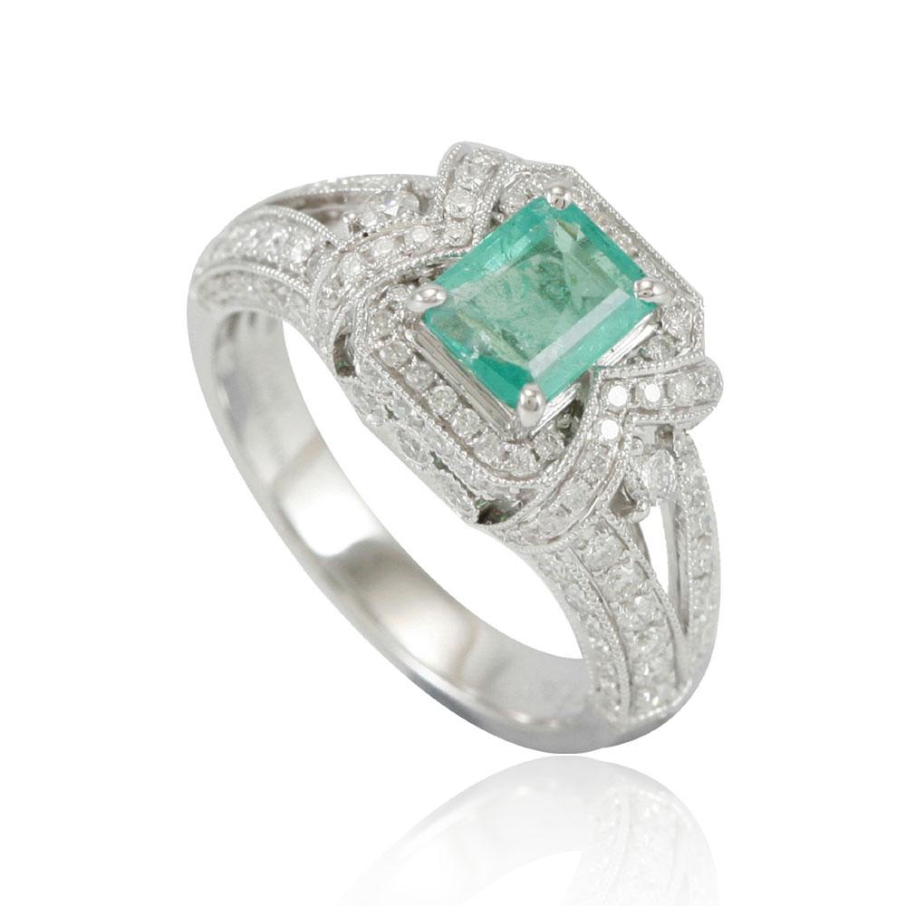 This spectacular ring from the Suzy Levian Limited Edition collection features a Colombian emerald gemstone held in a square shaped 14K white gold prong setting. An array of 114 side white diamonds (.93ct tdw) with hand-carved French filigree work