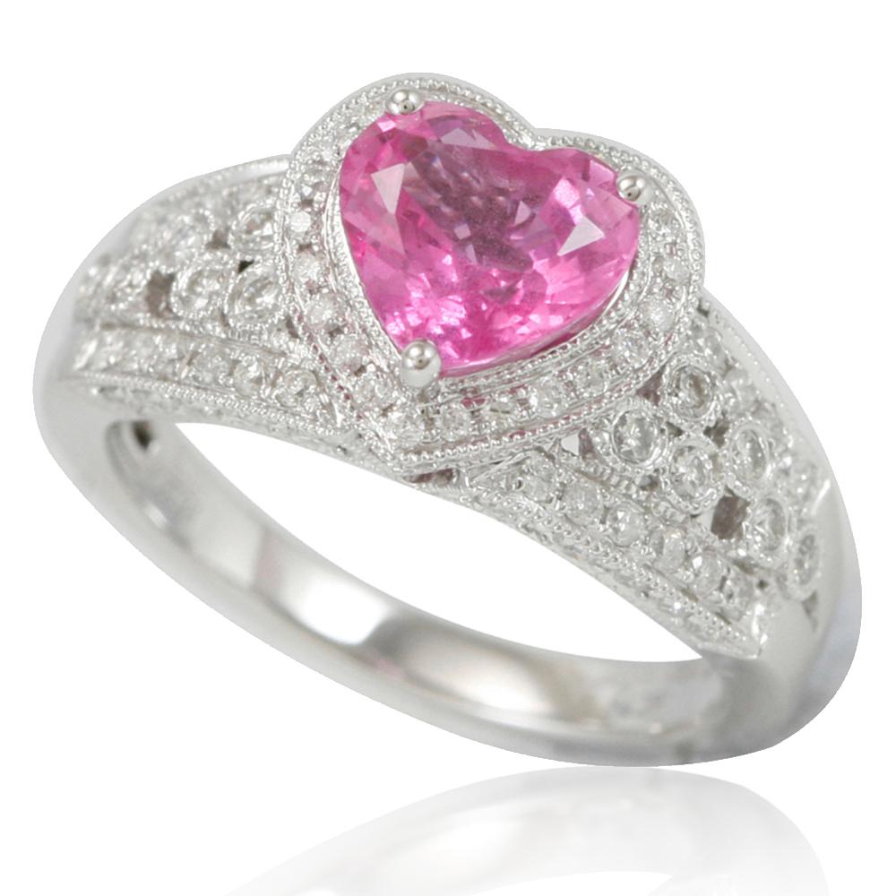 This spectacular cocktail cluster style ring from the Suzy Levian limited edition collection features a large ceylon pink sapphire held in a 14K white gold prong setting. An array of 110 smaller white diamonds (.78 TDW) with hand-carved French