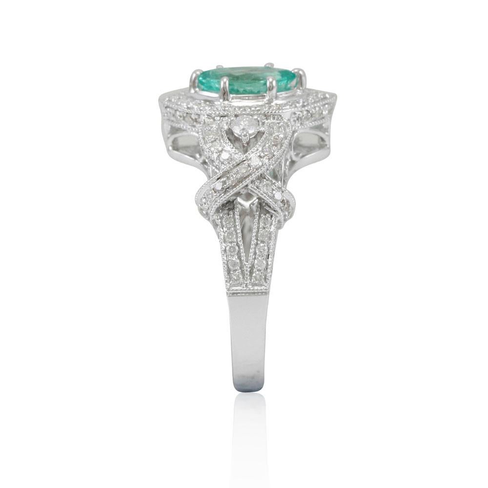 This spectacular ring from the Suzy Levian Limited Edition collection features a Colombian emerald gemstone held in a 14K white gold prong setting. An array of 102 side white diamonds (.70ct) with hand-carved French filigree work across the band,