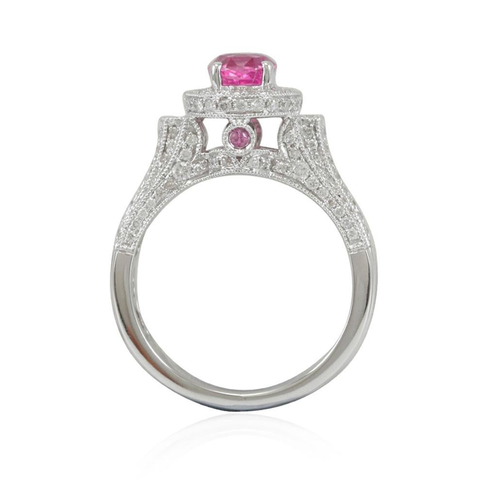 This spectacular elevated pink sapphire and diamond halo style ring from the Suzy Levian Limited edition collection features a large oval-cut, Ceylon pink sapphire center stone (1.66ct) held in a 14K white gold prong setting. An array of 145 smaller