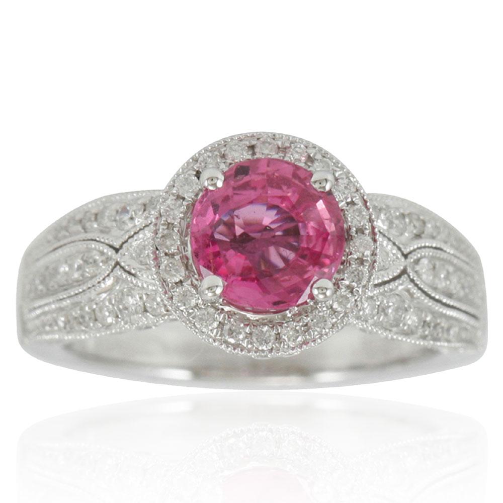 This spectacular cocktail cluster style ring from the Suzy Levian limited edition collection features a large ceylon pink sapphire center held in a 14K white gold prong setting. An array of 120 smaller white diamonds (.95cttw) with hand-carved
