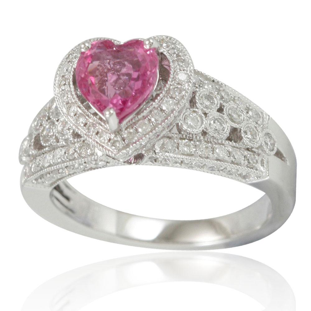 This spectacular cocktail cluster style ring from the Suzy Levian limited edition collection features a large ceylon pink sapphire heart held in a 14K white gold prong setting. An array of smaller white diamonds (.80cttw) set in pave and bezel