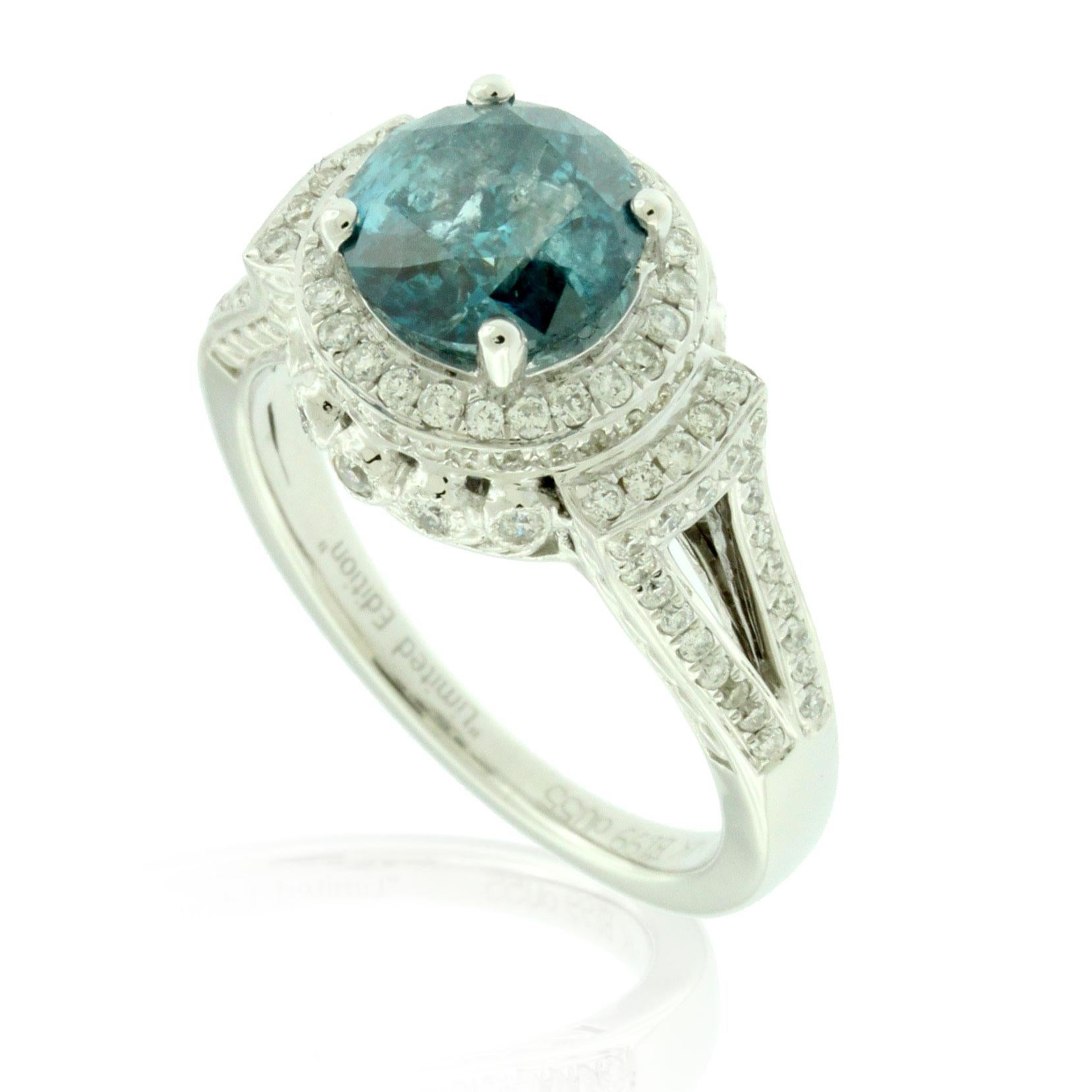 A rich blue diamond is prong-set atop this beautiful ring, surrounded by a halo of sparkling white diamonds. 

Center stone
Diamonds: One
Center cut: Round
Diamond weight: 1.64 carats
Color: Blue
Clarity: I1-I2
Setting: Prong
Side stones
Diamonds:
