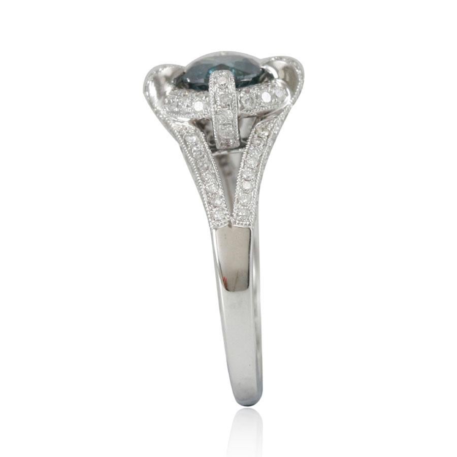 Featuring a 1ct blue diamond center stone, this Suzy Levian ring is accented with a channel-set 0.58ct white diamonds. Hand set in 14k white gold, this ring offers negative space in the shanks and glows elegantly with a high polish finish.

Blue